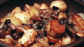 Potatoes with onion on clay plate.Closeup view.Roasted baby potatoes.Fried crispy potatoes. Cooking delicious potatoes fries in hot oil.Unhealthy and oily food. Fast food. - Powered by Shutterstock - Get 15% off with code: PIKWIZARD15