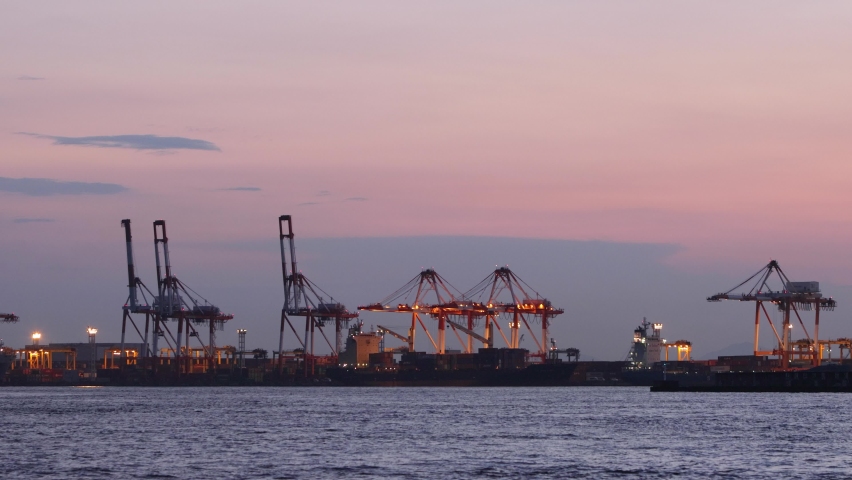 A gantry crane at the Port of Osaka, illuminated by the evening light. | Shutterstock HD Video #1080953318