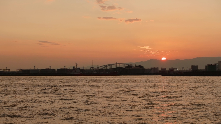 Beautiful sunset over the Yumeshima Bridge seen from Osaka Port. | Shutterstock HD Video #1080953321