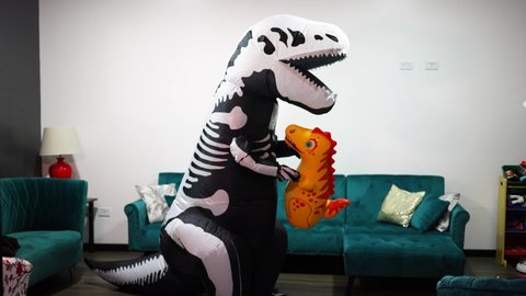 halloween dinosaur costume with man in the living room of the house