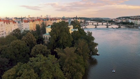 Beautiful Buildings Of Zofín Palace And Manes Exhibition Hall At The Waterfront Of Vltava River In Prague. ascending drone shot
