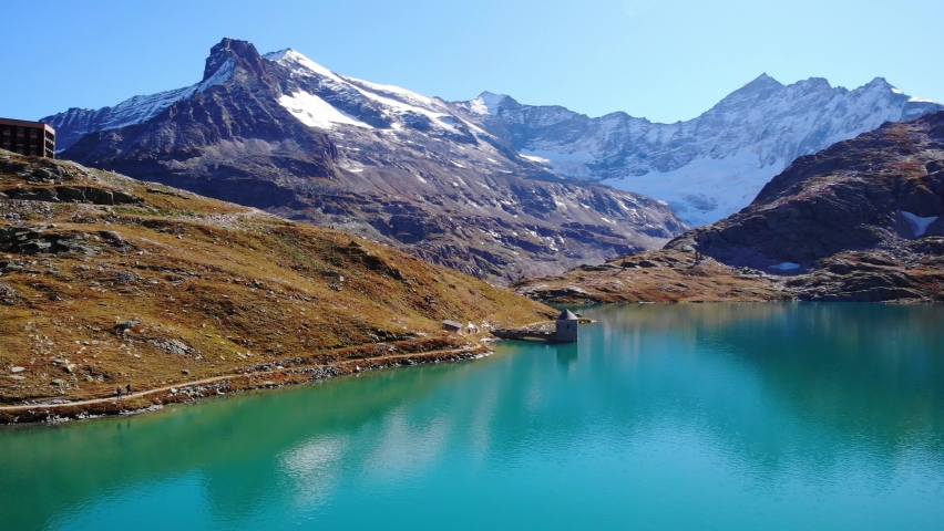 Snow Capped Mountain Of Grossglockner And Weisssee Lake In Salzburg, Austria. aerial