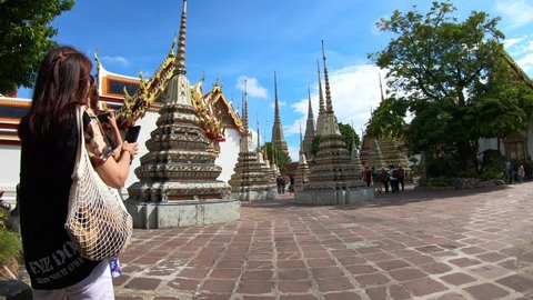 Bangkok, Thailand-July 17, 2019: Hyperlapse of Tourists getting around the Temple of Reclining Buddha (Wat Pho), Bangkok.  It is one of the most famous travel destinations in Thailand.
