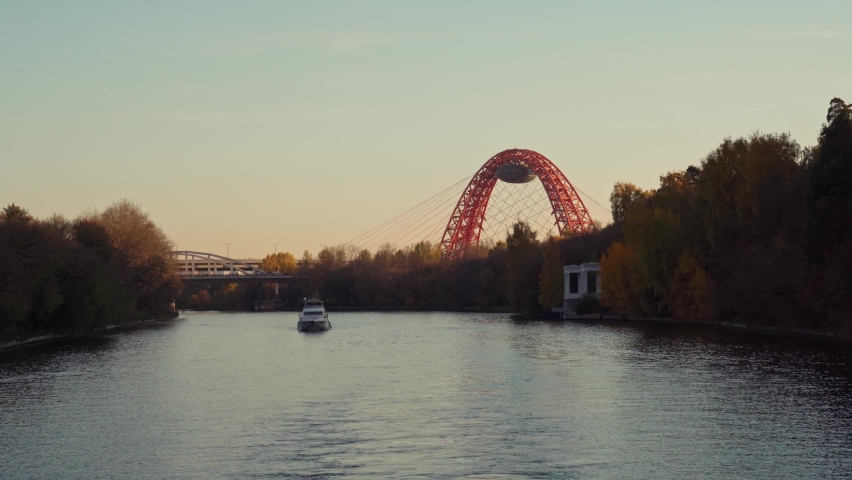 Autumn. Views from the side of a pleasure boat on the automobile and railway bridges across the Moscow  River at sunset.