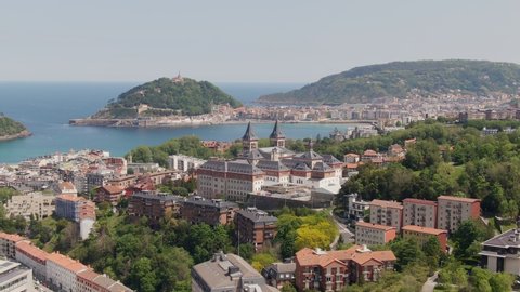Coastline city of San Sebastian with majestic towers, cinematic aerial view