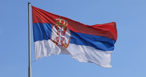 Serbian flag on pole, wind weather, day