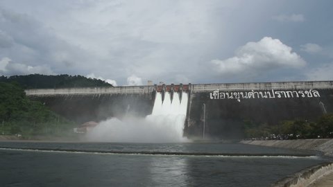 water splashing from floodgate huge concrete dam in Thailamd translation require for foreign language read Khun Dan Prakarn Chon is mean Ancient Thai worrior named Dan will protected people and water
