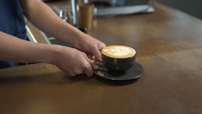 4K Asian man barista making hot coffee latte in coffee cup to customer on bar counter at cafe. Male coffee shop waiter serving hot coffee with milk to client. Small business restaurant owner concept. - Powered by Shutterstock - Get 15% off with code: PIKWIZARD15