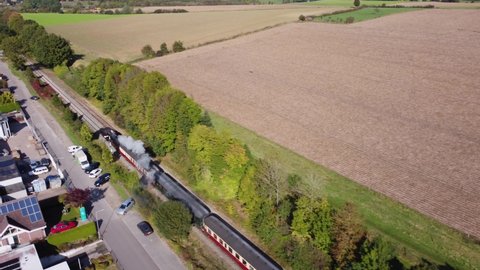 Netherlands - 16 october 2021, Wijlre, Limburg: Nostalgic historical Steam Locomotive drives through hilly landscape