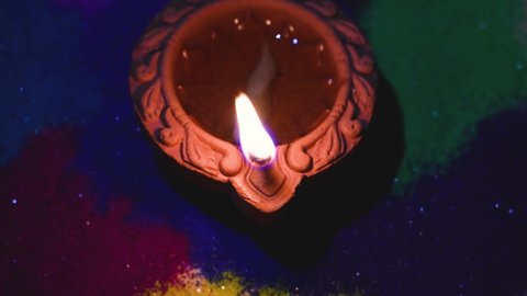Happy Diwali- Illuminating Diya with Rangoli during celebrating Indian festival Diwali