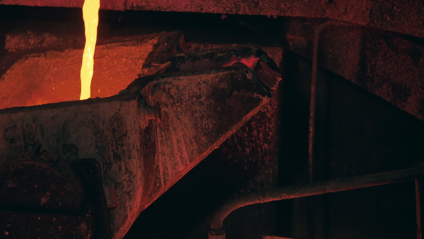 Foundry mechanism is pouring molten copper into a mold Royalty-Free Stock Footage #1081000820