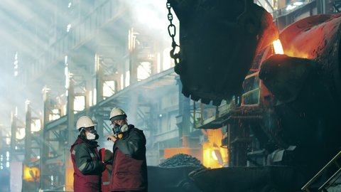 Steelworkers are observing and discussing foundry workshop