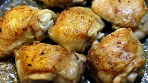 chicken thigh is fried in a pan at home. home cooking concept. home cooking. fried chicken until golden brown. home kitchen