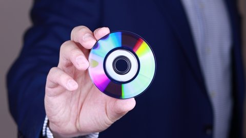Man showing mini compact disc