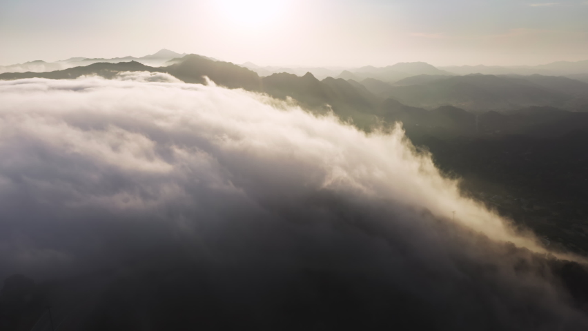Soaring in clouds like bird. Flying fast in clouds view from cockpit window. The clouds are moving on camera with golden cinematic sunset on background. Timelapse through the cloudscape in mountains Royalty-Free Stock Footage #1081004744