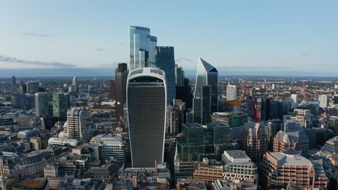 Slide and pan footage of group of modern tall skyscrapers in City business district. Walkie Talkie with Sky garden at top in foreground. London, UK