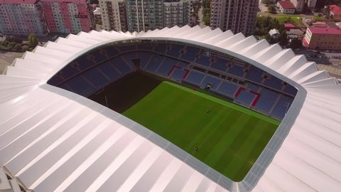 BATUMI, GEORGIA-AUGUST 30, 2021: Aerial flight on a throne from a bird's-eye view of the Dinamo Stadium in Batumi near Heroes ' Square against the backdrop of the urban landscape