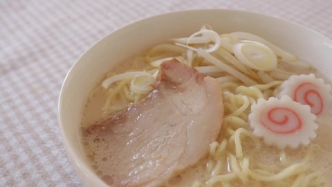 Serving the topping on pork bone thick soup noodles for Japanese food image