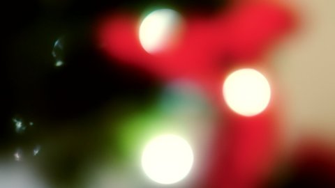 Detail of Christmas tree in 4K VIDEO. Decoration, ornaments, lights and needles. Shallow depth of field and blurred background. Close-up.