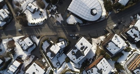 Aerial shot of a village in Switzerland that was covered in snow at a popular destination for skiers