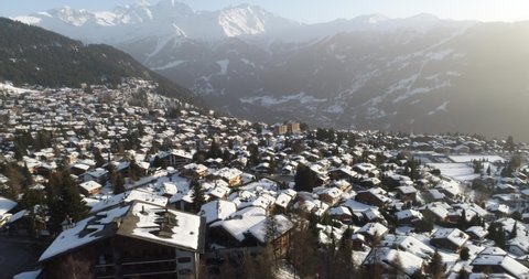 Aerial shot of a village in Switzerland that was covered in snow at a popular destination for skiers