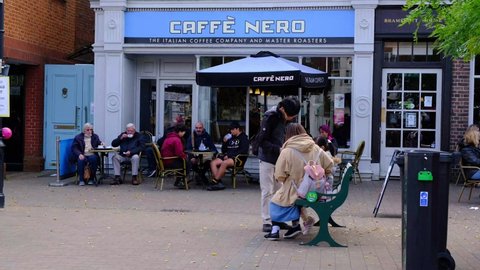 Epsom Surrey, London UK, October 17 2021, Old and young Multi Ethnic People Sitting Outside A Caffe Nero Coffee Shop Relaxing and Drinking With People Of Shoppers Walking Past