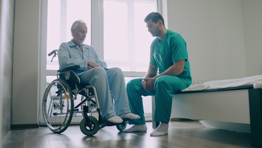 Professional physical therapist helping elderly man to do exercise, mobility | Shutterstock HD Video #1081038965