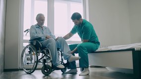 Professional physical therapist helping elderly man to do exercise, mobility - Powered by Shutterstock - Get 15% off with code: PIKWIZARD15