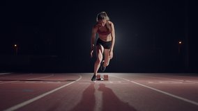 slow motion female runner at the start close-up in the dark at the stadium professional runner athletic - Powered by Shutterstock - Get 15% off with code: PIKWIZARD15