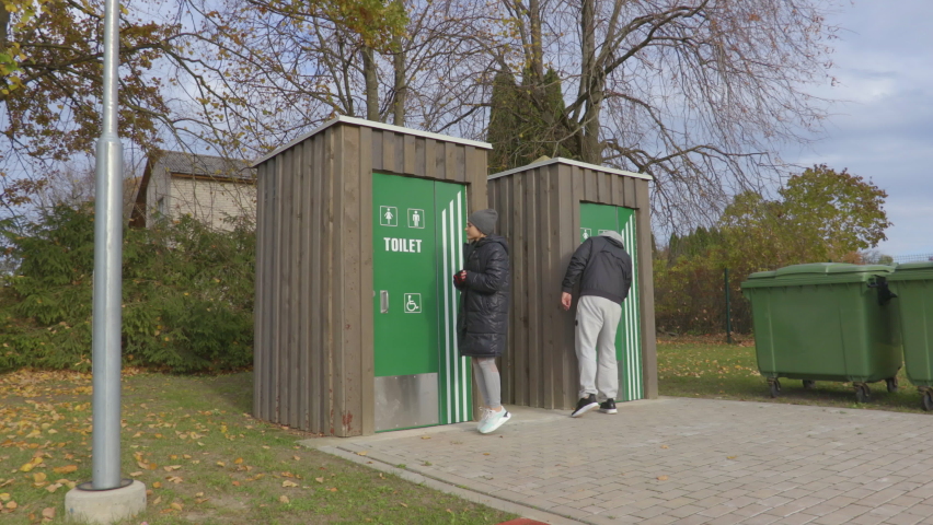 Man and woman near toilets on stadium