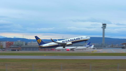Oslo Airport Norway - October 10 2021: airplane boeing 737 ryanair taking off panning right ambient sound