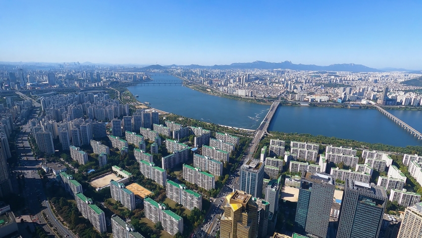 Cloudless Seoul Skyline with riverbanks of Han river. Cityscape view from tallest building aerial panorama 4k timelapse South Korea, time lapse