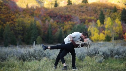 Heterosexual Couple in Love Kissing with Beautiful Forest Background