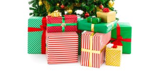 Animation of christmas presents and tree on white background. christmas, tradition and winter celebration concept digitally generated video.