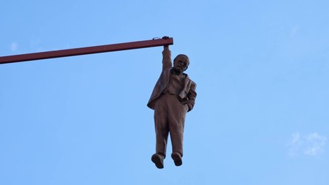 Prague, Czech Republic - August 30, 2021: Man Hanging Out created by the artist David Cerny. Sculpture of the psychoanalyst Sigmund Freud hanging by a hand.