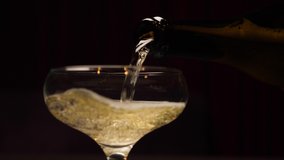 Bottle champagne slow pouring in glass closeup. Sparkling wine slow motion. Close up pour champagne in glass. Sparkling wine bottle pouring into glass. Celebration champagne new years eve party drink - Powered by Shutterstock - Get 15% off with code: PIKWIZARD15