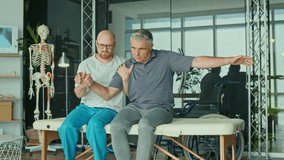 A Sick Man With a Brain Stroke Undergoes a Rehabilitation Program with a Physiotherapist in a Modern Clinic. Incapacity for Work, Limited Movement, Paralysis. Elderly Health Support Concept. - Powered by Shutterstock - Get 15% off with code: PIKWIZARD15