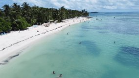View with drone over beautiful San Luis beach in San Andres, Colombia with a view of the sea of 7 colors, full of people enjoying their vacations.