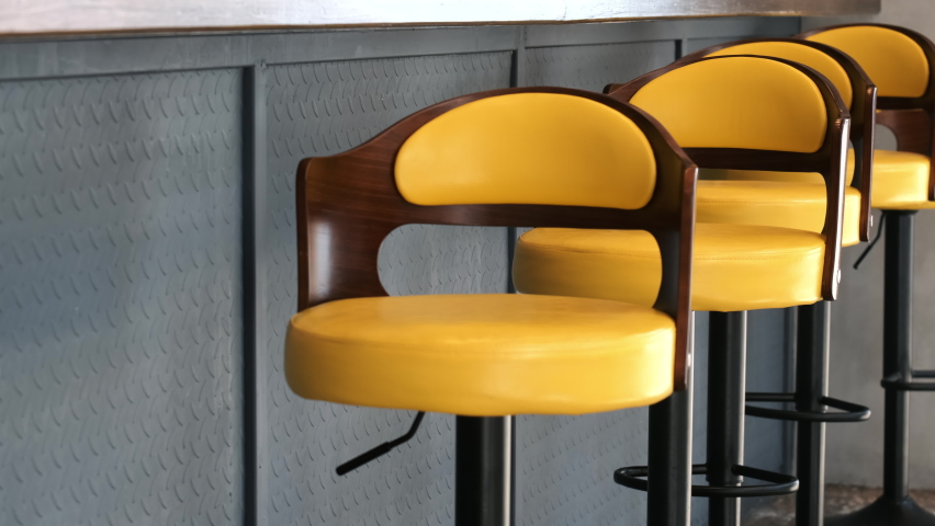 Close up of empty yellow bar retro chairs outdoor. Royalty-Free Stock Footage #1081067708
