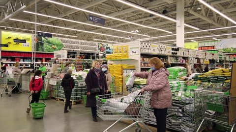 People go to the garden goods store. Store warehouse of materials for the improvement and repair of houses and countryside suburban areas Leroy Merlin. Perm, Russia, April-18,2021.