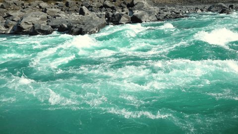 Mountain river rapids of running waters. Autumn highlands streaming creek. Natural streaming creek. Tourism and traveling in Altai mountains. Wild natural sight of autumn. High land rivers rapids.