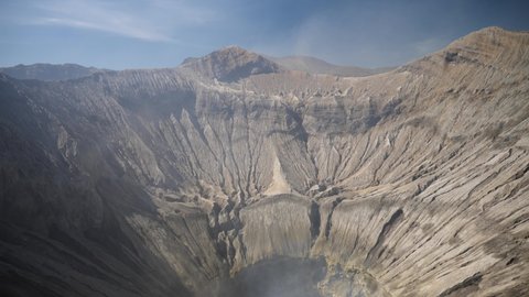 Mount Bromo Crater, active volcano with smoke in East Jawa, Indonesia. Aerial view of volcano crater Mount Gunung Bromo, active volcano, Tengger Semeru National Park. 4K video. Wonderful Indonesia.
