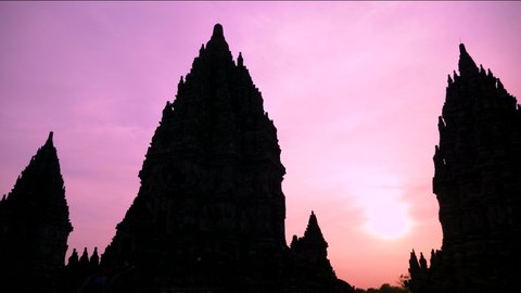 Silhouette of Prambanan Temple an ancient architecture, statues, carved stone walls. Sunset at Hindu temple Prambanan in Yogyakarta, Indonesia. UNESCO Hinduism Complex close to Yogyakarta. 4K video.