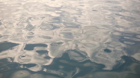 Close up view 4k stock video footage of beautiful clear and clean blue smooth surface of peaceful rippling waves of sea water. Abstract liquid organic background
