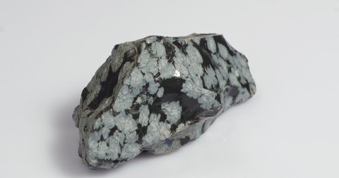 Mineral snow obsidian. The stone is of volcanic origin on a white background.