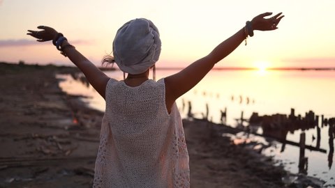 Hippie woman wear silver rings with stone and white blouse stands back at sunset. Indie boho vibes and bohemian style