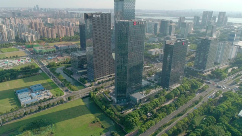 Aerial cityscape skyscrapers and glass office buildings with the reflections on windows on sunny day in Suzhou Industrial Park.