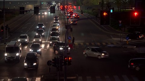 Lights of the night city. Cars are standing on a red traffic light. Crossroads. Traffic in the city. Transport. Milan Italy October 2021 