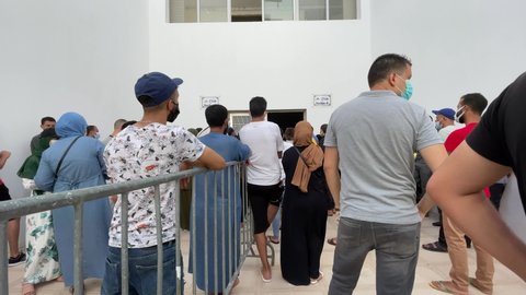 Morocco - August 18, 2021; Lots of Moroccan people waiting outside a Covid-19 vaccination centre