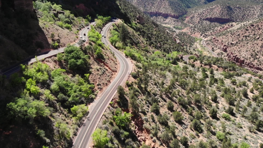 Winding Route in Zion National Park, Utah, USA. Aerial View of Scenic Landscape on Sunny Day, Tilt Up Drone Shot